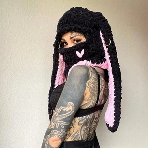Detail of crochet balaclava with black and pink rabbit ears and metal ring accent