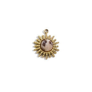Macro shot of 14K gold sun pendant with round brown gemstone for DIY jewelry making