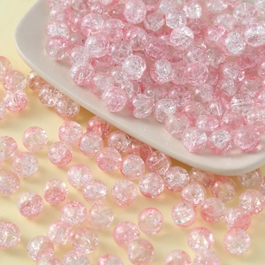 Macro detail of 10mm pink cracked glass beads for handmade jewelry and bracelets