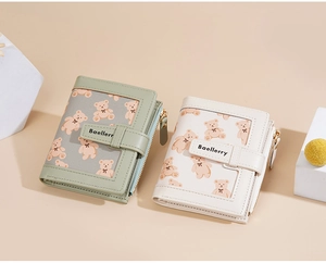 Close-up of compact bear print wallets in green and beige with zipper coin pocket