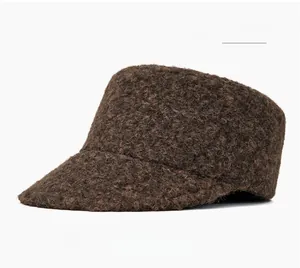 Detail of coffee brown wool blend flat top hat featuring thick textured bouclé fabric