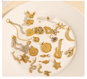 Macro view of assorted 18K gold-plated DIY pendants with sparkling rhinestones and pearls