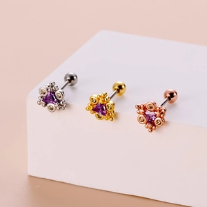 Macro view of stainless steel screw back stud earrings with purple triangle gemstones