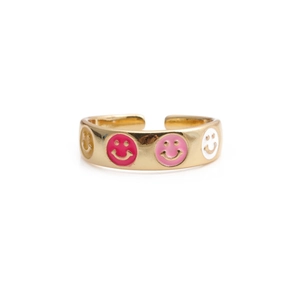 Close-up of golden adjustable ring with four colorful enamel smiley face patterns