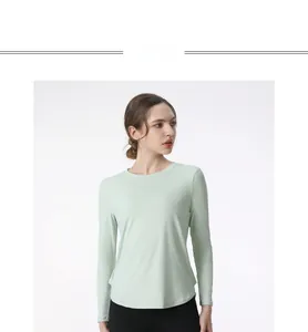 Close-up of light mint green yoga top showing moisture-wicking fabric and curved hemline