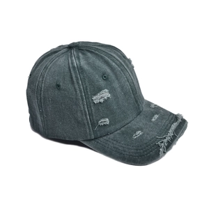 Macro detail of distressed vintage cotton canvas with frayed edges on a washed baseball cap