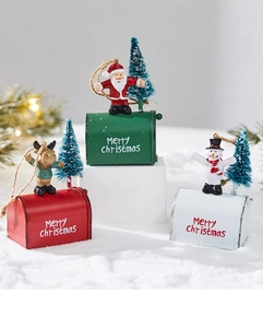 Detail of Christmas iron mailbox ornaments featuring Santa, reindeer and snowman figures