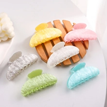 Collection of six colorful butterfly hair claws with elegant marble textures and patterns