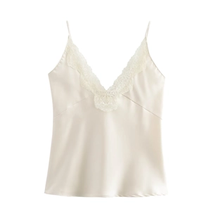 Detail of V-neck lace trim and silky satin fabric on cream white camisole top