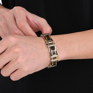 Close-up of bicolor titanium steel hip hop bracelet with carbon fiber inlay on wrist