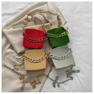 Flat lay of colorful metallic square hard shell clutch bags with chunky chain straps