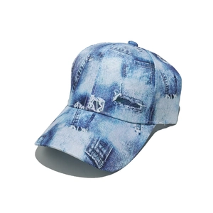 Detail of light blue vintage denim print baseball cap with faux distressed patch patterns