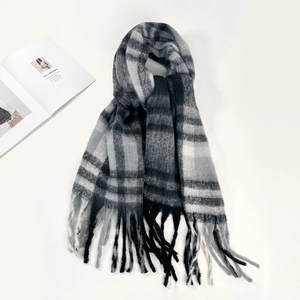 Detailed view of striped plaid mohair scarf with soft texture and long fringe tassels
