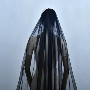 Detailed view of long black tulle wedding veil with floor-length cathedral train style