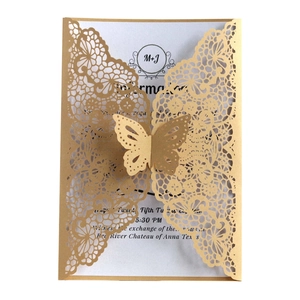 Detailed laser-cut lace pattern and 3D butterfly closure on wedding invitation