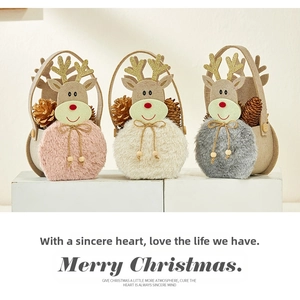 Three plush reindeer Christmas gift bags in pink, white, and gray with glittery antlers