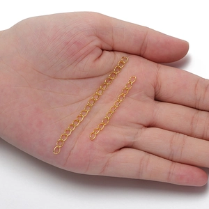 Golden metal extension chains in two lengths for DIY jewelry making on model palm