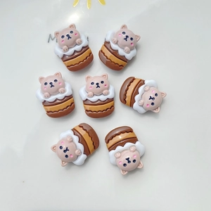 Detail view of seven resin Shiba Inu cupcake DIY charms on a white decorative plate