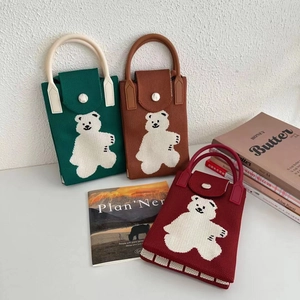 Detailed knit texture and button closure on mini cat-themed knitted crossbody bags