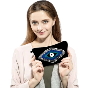 Portable black Evil Eye print makeup bag with blue eye pattern and metal zipper closure