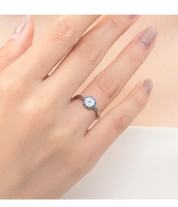 Close-up of s925 silver Evil Eye ring with blue and white crystals on finger