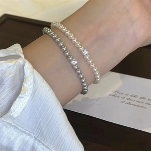 Elegant zircon pearl bracelets set with square crystal charms on a woman's wrist