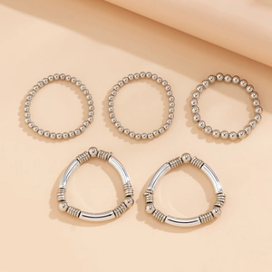 Detailed close-up of a 5-piece silver metal beaded bracelet set with heart charms