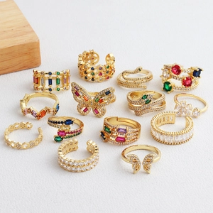 Detail of colorful zircon gold rings set featuring butterfly and snake designs
