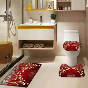 Christmas themed bathroom set with red rugs and seat cover featuring golden star patterns