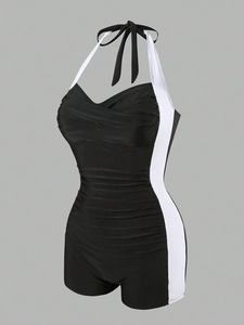 Detail of ruched front panel and white side stripes on black halter neck swimsuit
