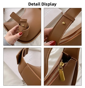 Détail du sac selle en cuir marron avec boucle en métal doré et fermeture éclair fluide