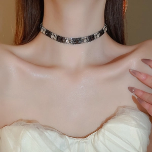 Macro view of French style square zircon choker necklace with sparkling black and white stones