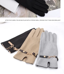 Close-up of winter thermal gloves with elegant metal buckles and fleece lining
