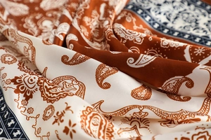 Macro shot of smooth silk-like texture with paisley pattern on square headscarf