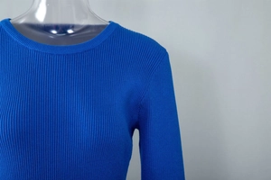 Close-up of royal blue ribbed knit texture and crewneck design on fitted dress