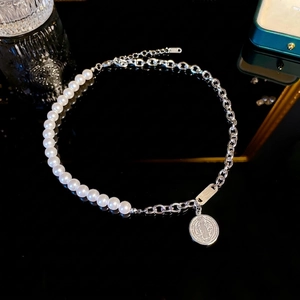 Minimalist pearl and silver chain necklace with a vintage medallion pendant