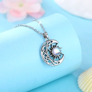 Retro silver sun and moon pendant necklace with iridescent gemstone and celtic knot