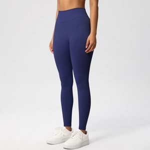 Detail of high-waist seamless deep blue yoga leggings showing body-contouring compression
