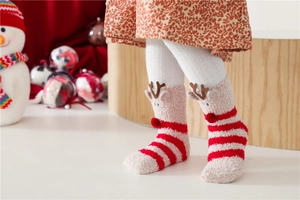 Detail of plush Christmas elk socks for kids with 3D reindeer horns and red pom nose