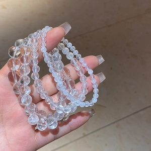 Close-up of clear white crystal beaded bracelets showing high transparency and luster