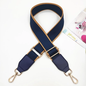 Adjustable dark blue cotton crossbody strap with brown trim and gold metal clasps