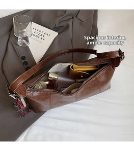 Close-up of the large interior capacity of this brown vintage PU leather shoulder bag