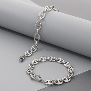 Macro detail of silver pig nose anchor link bracelet with polished steel finish