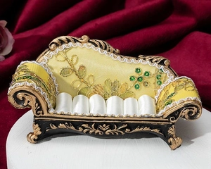 Detailed view of vintage sofa jewelry box with gold floral embroidery and ring slots