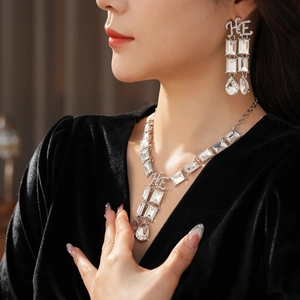 Macro view of crystal necklace and earrings set featuring rectangular and teardrop stones