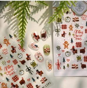 Detail of Christmas nail art stickers featuring dachshunds and gingerbread man designs