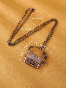 Detail showing vintage amethyst star moon pendant necklace size 5cm by 4.2cm on fabric