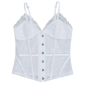Close-up of white lace corset top featuring intricate floral patterns and metal eyelet buckles