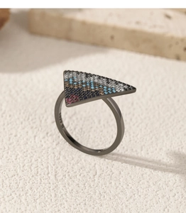 Macro detail of S925 sterling silver stamp on a dark ring with colorful mosaic gems