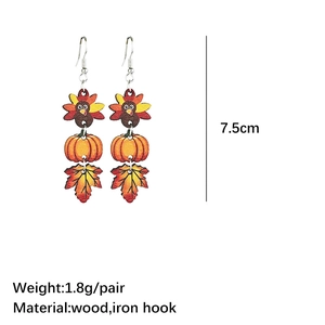 Detail of wooden Thanksgiving earrings showing turkey and pumpkin motifs with 7.5cm length